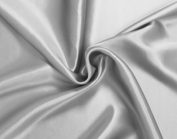 Close-up on a twisted section of our Silver Mulberry Silk Pillowcase to showcase its smooth, luxurious fabric.