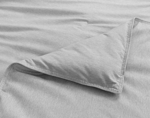 Close-up on a folded corner on our Heathered Jacquard Comforter Set in Grey with its slight flanged edge.