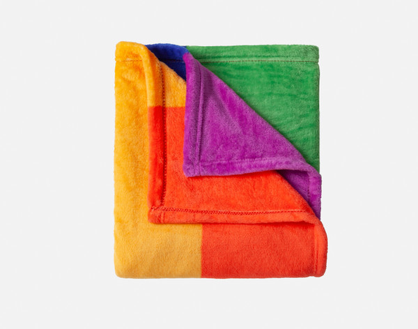 Our traditional Pride Rainbow Fleece Throw folded into a square to show its brightly coloured surface.