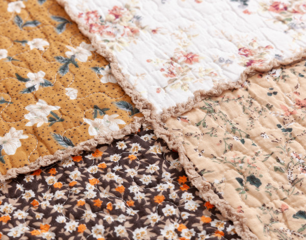 Close-up on the fringed border and diverse patchwork squares on our Annie Mae Cotton Quilt Set.