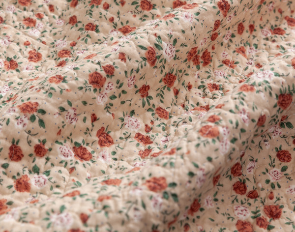 Close-up of the scattered rose design on the reverse side of our Annie Mae Cotton Quilt Set.