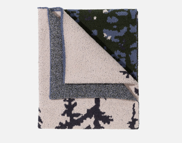 Top view of our Chenille Jacquard Throw in Deep Woods folded into a tidy square.