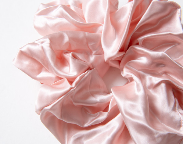 Close-up on the lustrously soft and ruffling surface on our Mulberry Silk Oversized Scrunchie in Blush.