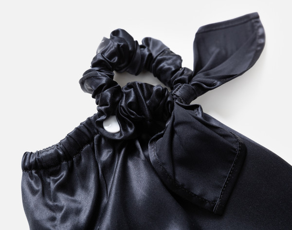 Close-up on the scrunchie opening on our Mulberry Silk Bun Cover in Black.