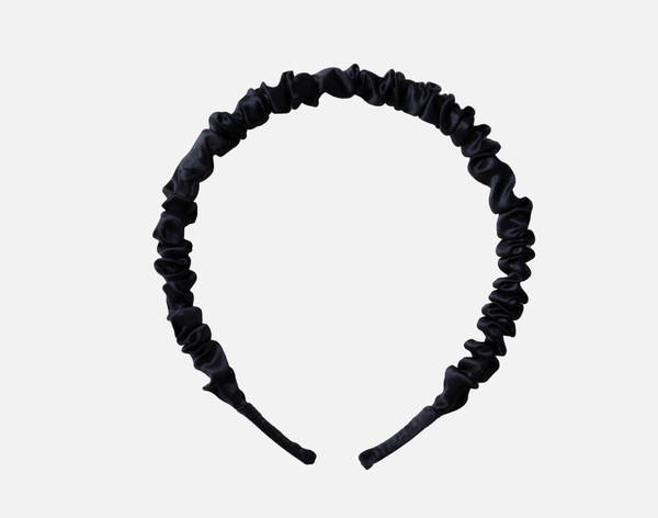 Front view of our Mulberry Silk Wrapped Hairband in Black resting on a solid white background.