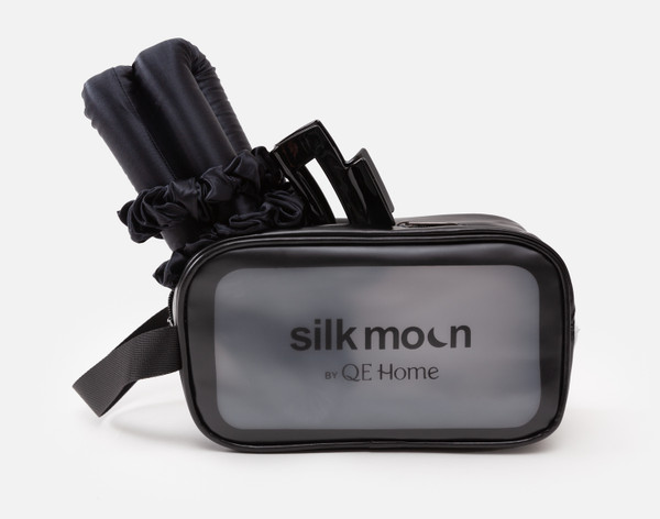 Front view of our Silk Wrapped Heatless Curler Set in Black poking out of its packaging.