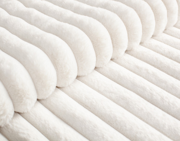 Close-up on the ribbed velvety soft texture on our Channel Faux Fur Comforter Set in Winter White.