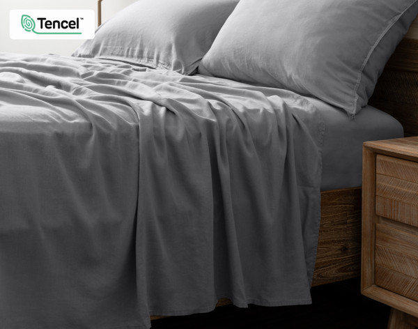 Side view of our Hemp Touch Sheet Set in White to show its flat sheet draping over its side.