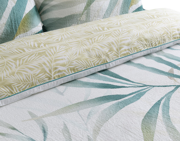 Close-up view of our Bonita Duvet Cover to show its hand-painted palm leaves and tight leaf print backing together.