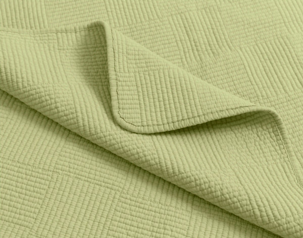Folded corner of our Kenzie Cotton Quilt Set in Stem Green.