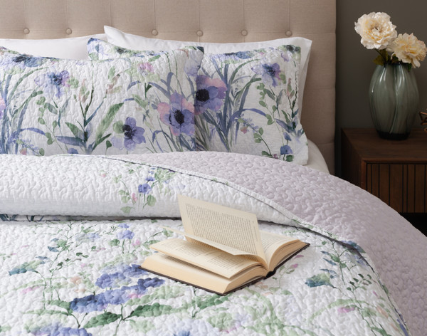 Closer view of our Evelyn Coverlet Set on a queen bed with a book half-open overtop.