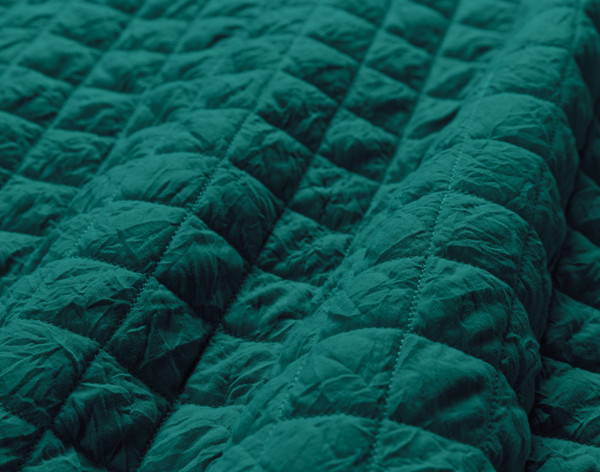 Close-up of the diamond stitching over our Rumple Crumple Coverlet Set in Deep Teal.