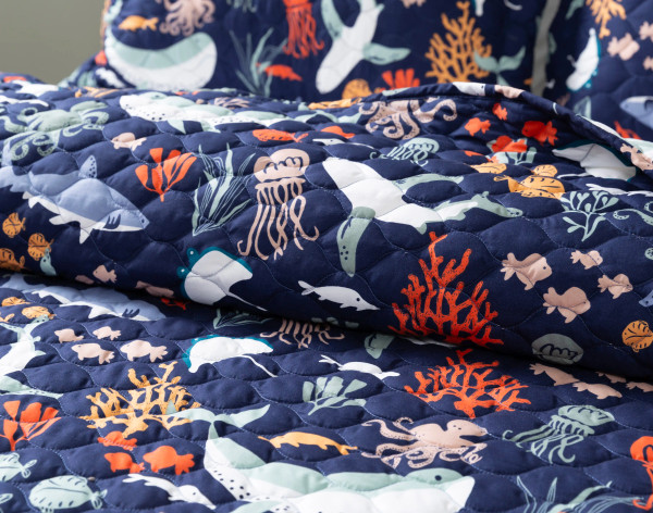 Folded top end of our Sea Creatures Coverlet Set to show its soft surface.