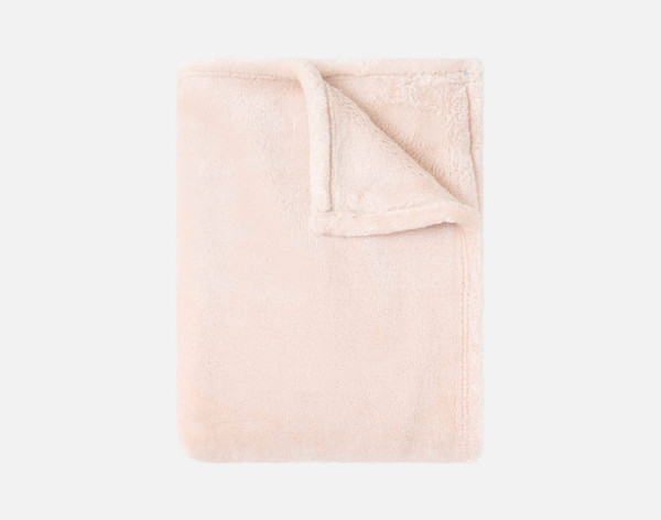 Our Velveteen Throw in Peach Blush folded neatly into a tidy square.