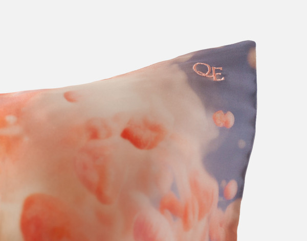Close-up on the embroidered QE Home logo on the corner of our Mulberry Silk Pillowcase in Georgia.