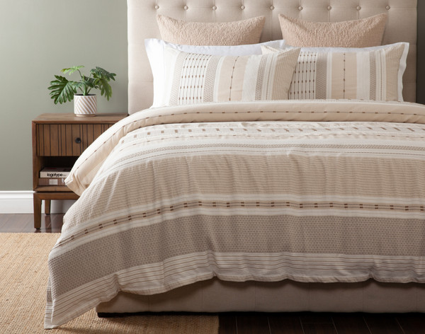 Off-centre front view of our Adrift collection dressing a queen bed in a simple bedroom.