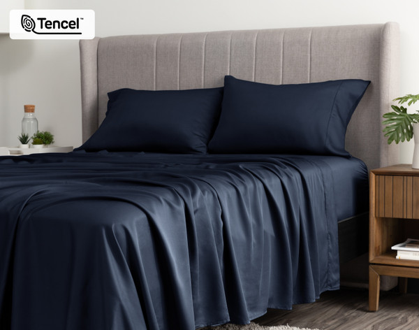 Angled view of a queen bed dressed in our BeechBliss TENCEL™ Modal Sheet Set in Deep Space.