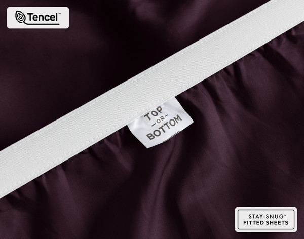 Close-up on the stretched elastic edge and tag stating "Top / Bottom" on our Eucalyptus Luxe TENCEL™ Lyocell Fitted Sheet in Purple.