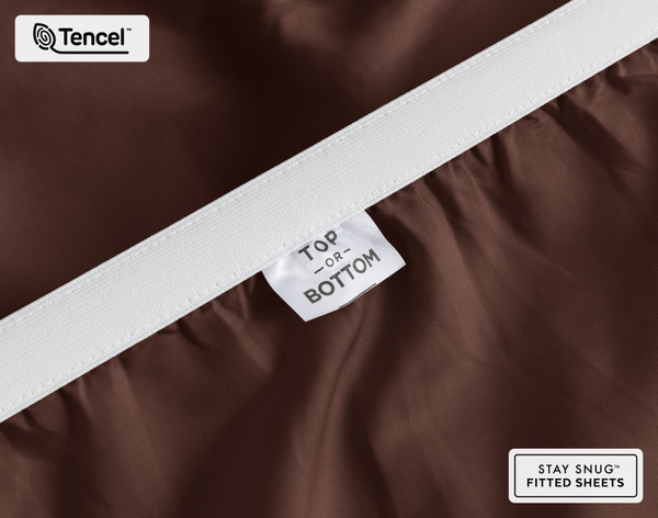 Close-up on the stretched elastic edge and tag stating "Top / Bottom" on our Eucalyptus Luxe TENCEL™ Lyocell Fitted Sheet in Chestnut.