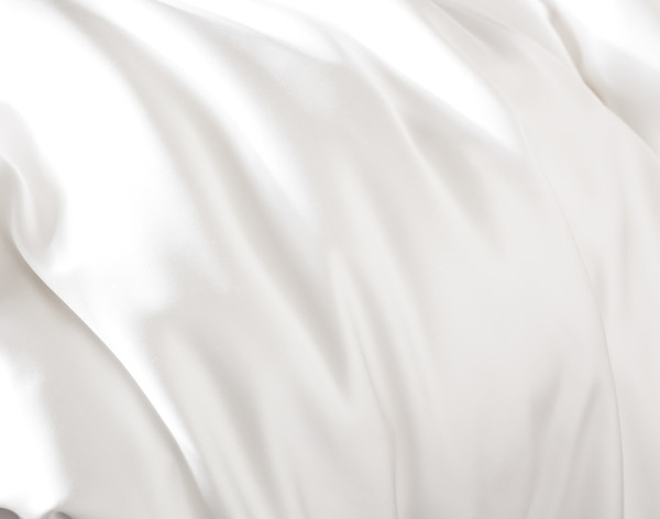 Close-up of bunched up fabric on our Silk Blend Fitted Sheet in Snow to show its shine & softness.