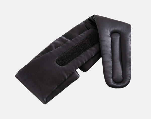 The reverse side of our 100% Mulberry Silk Blackout Sleep Mask in Black on a white background, showing the velcro fastening undone.