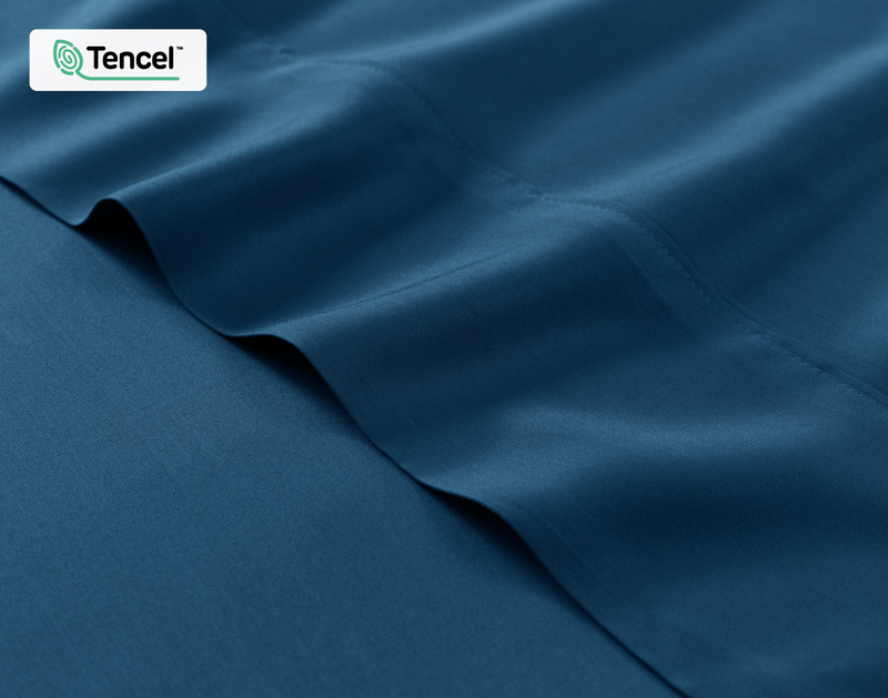 Close-up on the fitted and flat sheet of our BeechBliss TENCEL™ Modal Sheet Set in Seaport Blue to show its silky soft surface.