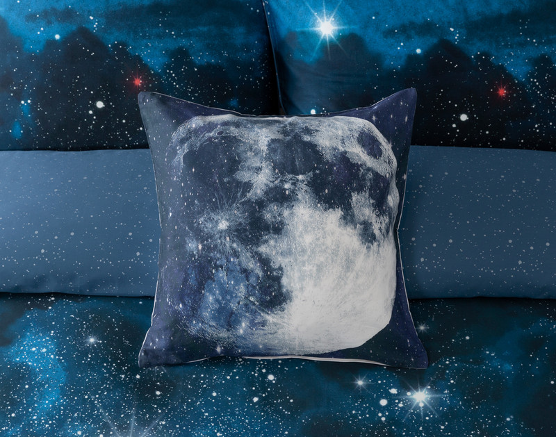 Front view of our Supernova Square Cushion Cover sitting over a coordinating duvet cover.
