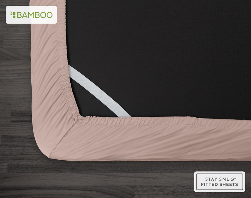 Bottom view of our Bamboo Cotton Fitted Sheet in Blush Pink to show its Snug Fit elastics holding the corner in place over a mattress.