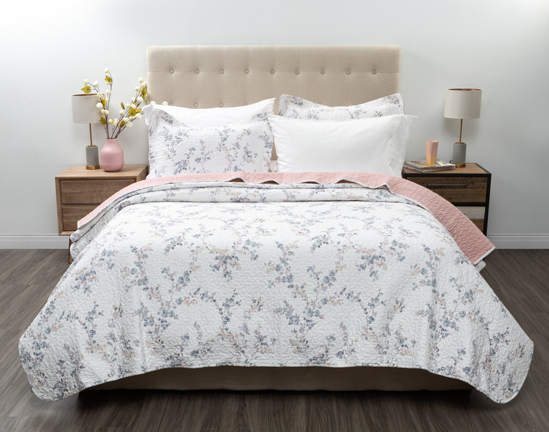 Front view of the Annalise Cotton Quilt Set dressed over a queen bed in a plain white bedroom.