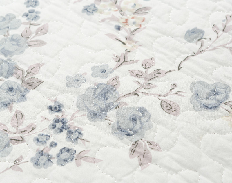 Close up of the botanical print on Annalise's white cotton shell background.