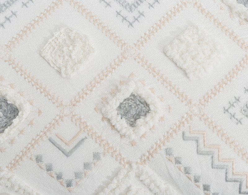 Close up view of the Charity Duvet Cover intricate geometric embroidery.