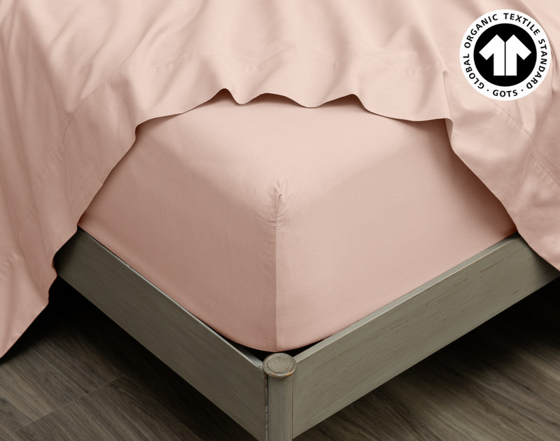 Close-up on the corner of our 300TC Organic Cotton Fitted Sheet in Rose Smoke wrapped around a mattress.