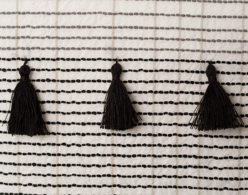 Close up of black tassels on Mitchell Square Cushion Cover.