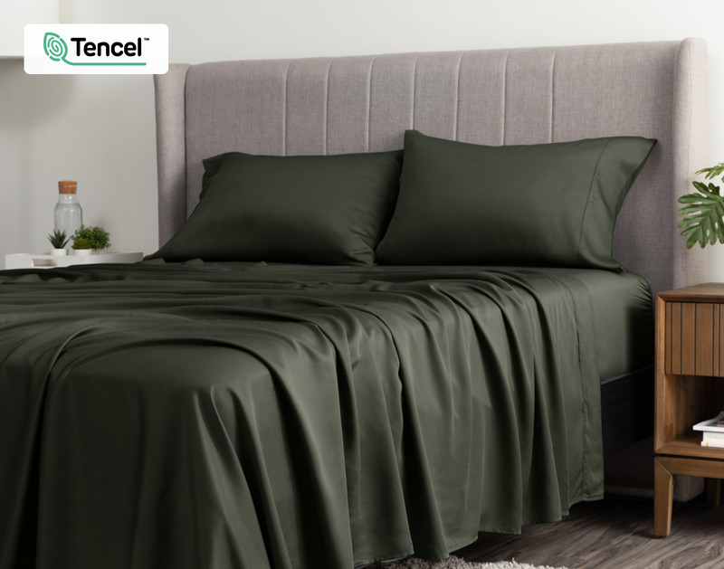 Angled view of a queen bed dressed in our BeechBliss TENCEL™ Modal Sheet Set in Rainforest Green.