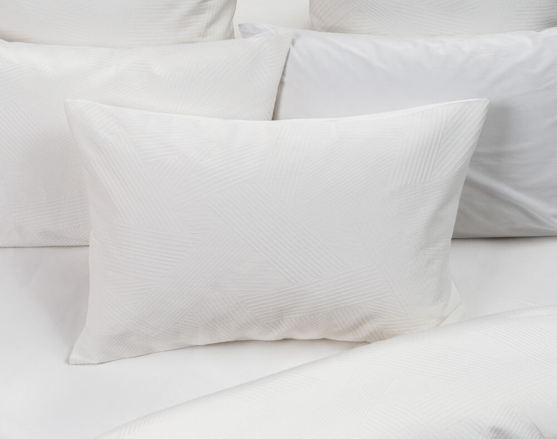 Our Osmond White Pillow Sham over Osmond Bedding.