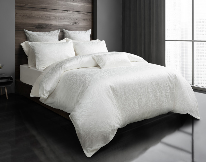Our Blanchard White Duvet Cover and features a textured jacquard pattern of white tree branches.