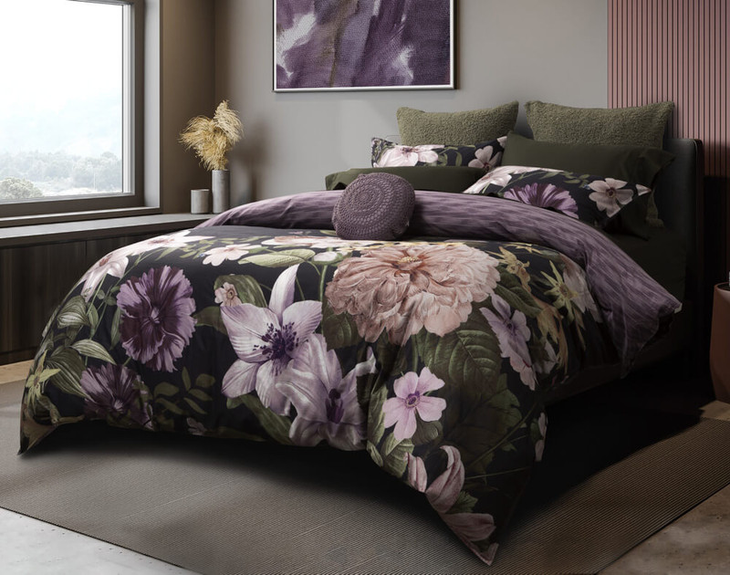 Our Greta Floral Duvet Cover features dark purples and rainforest greens on a deep black background.