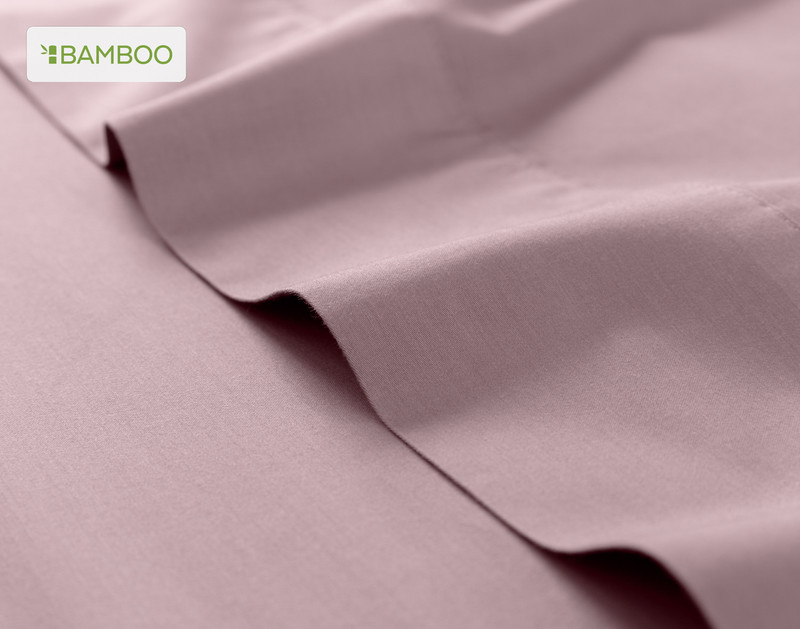 Flat sheet for our Bamboo Cotton Sheet Set in Orchid Purple ruffled lightly over a matching smooth surface.