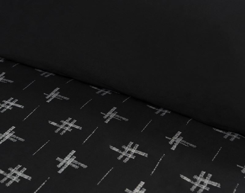 Close-up of our Ikat Organic Cotton Duvet Cover Set folded over to show black reverse.