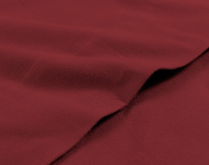 Soft edge of our Red Flannel Sheet Set in Rhubarb.
