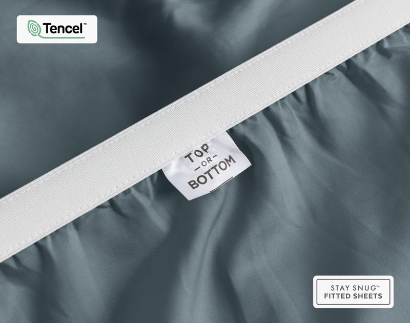 Close-up on the stretched elastic edge and tag stating "Top / Bottom" on our Eucalyptus Luxe TENCEL™ Lyocell Fitted Sheet in Thundercloud.