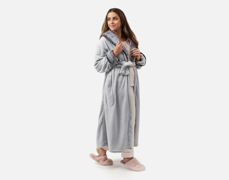 Woman smiling wearing Plush Faux Fur Bathrobe in Silver with soft blush pink slippers.