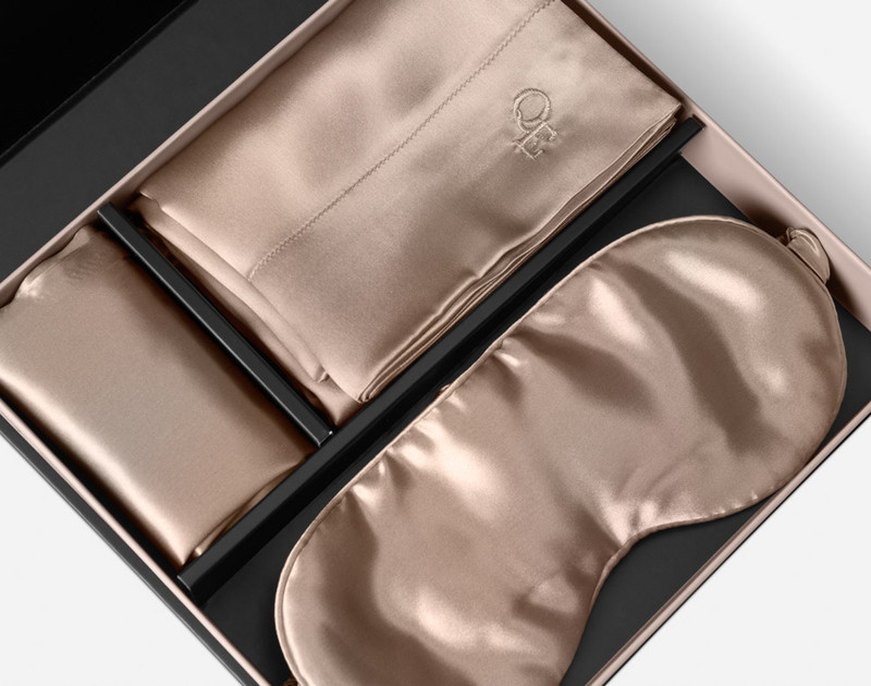 The silk pillowcase, eye mask, and delicates bag of our Mulberry Silk Gift Set in Bronze folded in its packaging.