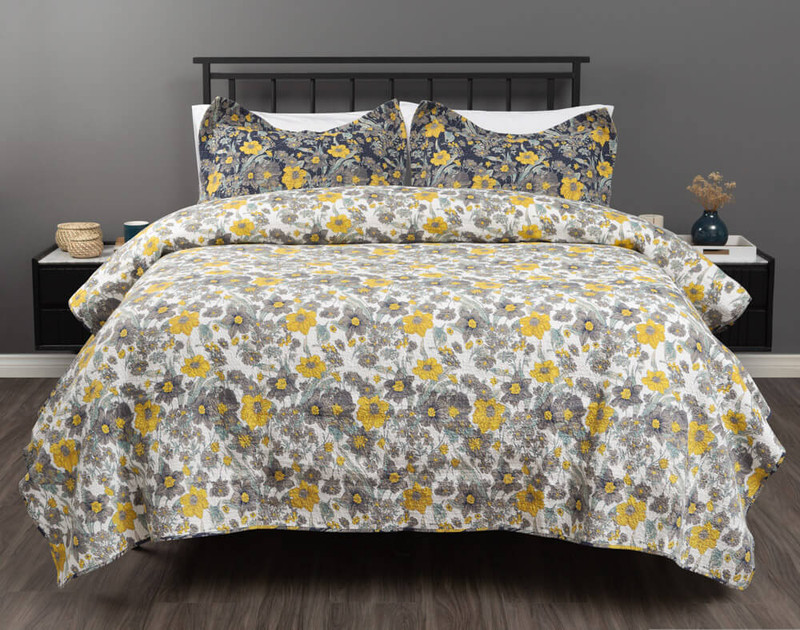 Reverse of our Eloise Floral Cotton Quilt Set features natural grey & yellow daisies on a white background.