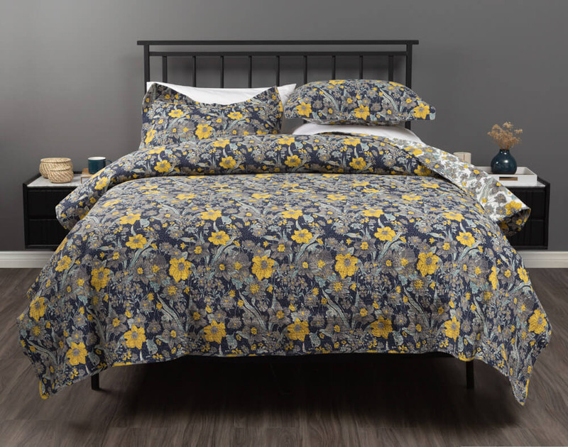 Our Eloise Floral Cotton Quilt Set, featuring natural grey & yellow daisies on a navy background.