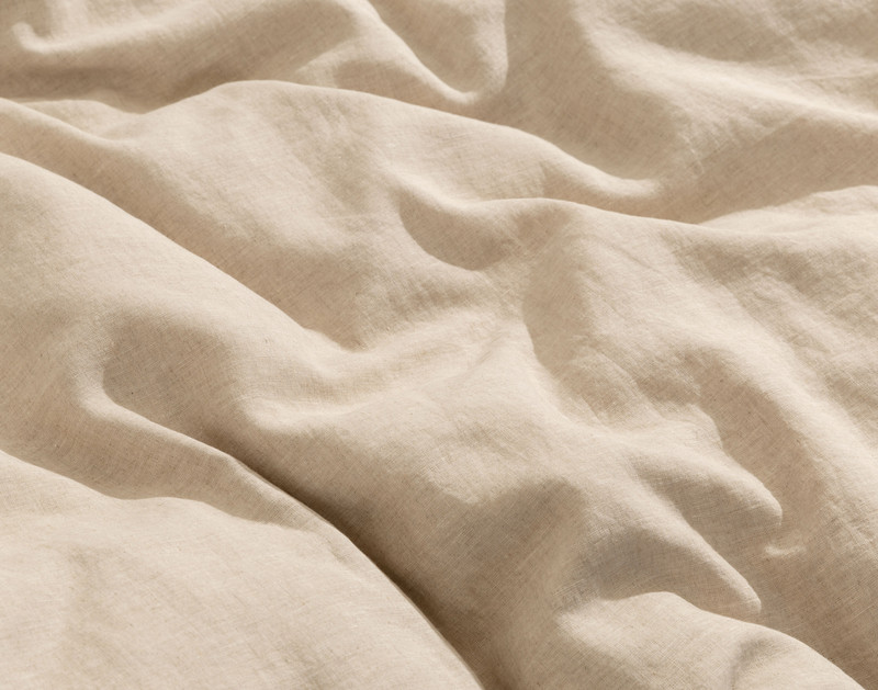 Close-up on the luxuriously soft and lightly heathered linen fabric on our Signature European Linen Duvet Cover in Natural.