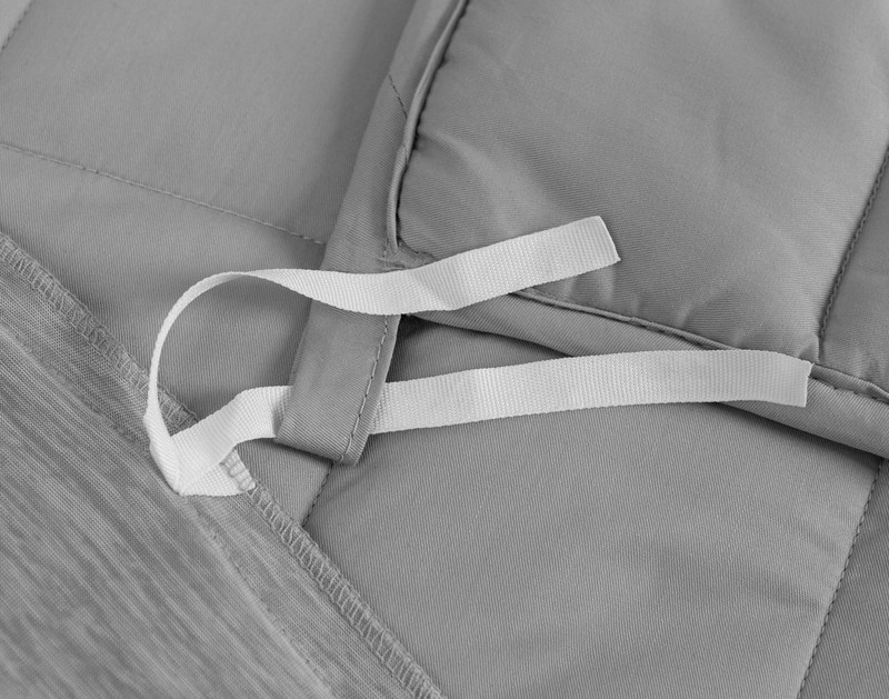 Inner tie loosely knotted around the inner corner of our Cool Touch Weighted Blanket Cover.