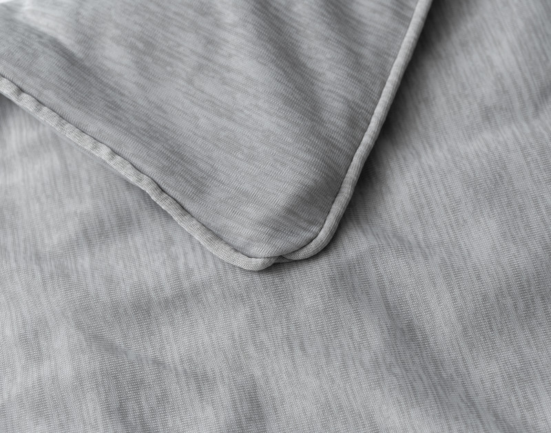 Corner of our Cool Touch Weighted Blanket Cover to show its light piped edge.