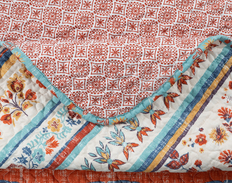 Close-up on the corner of our Ferrah Coverlet Set to show its curved corner and solid border edge.