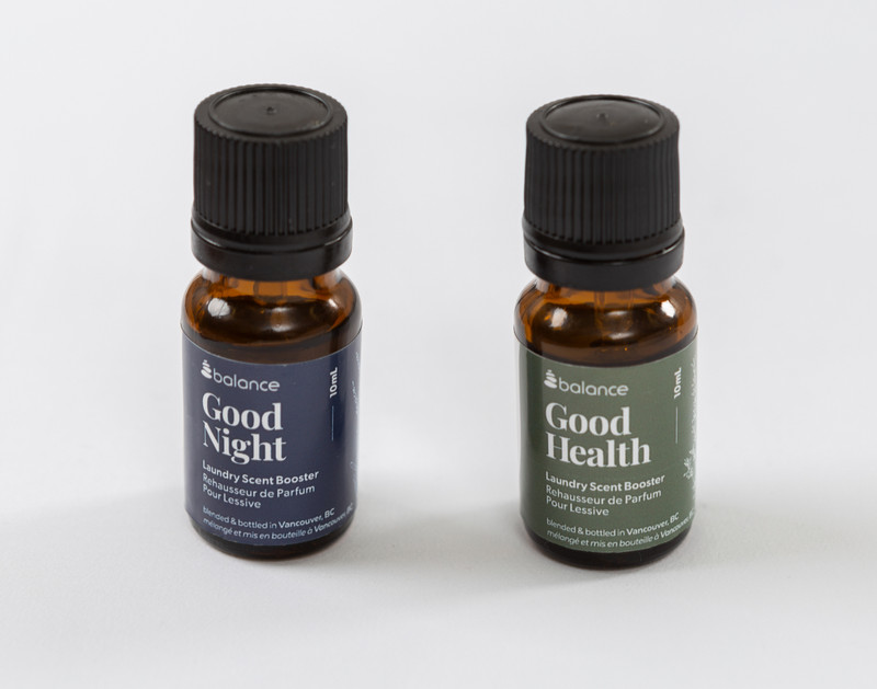 Our Good Health and Good Night Laundry Blend Essential Oil Bottles sitting beside each other on a solid white background.